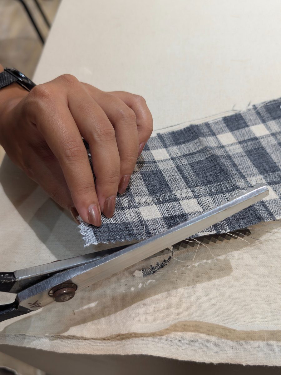 Cutting fabric by hand at Studio Half Meter tailoring studio, Pune